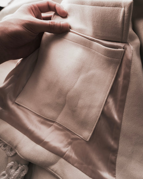 Close-up of a person adjusting the collar of a Dune Hanfu Jacket by Hannovae