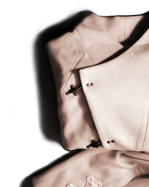 Close-up of a beige coat with floral embroidery on a white background of the DUne Hanfu Jacket by Hannovae