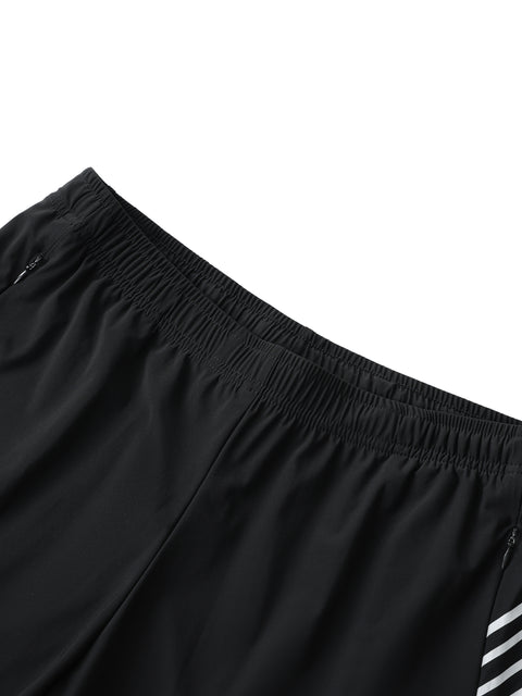 Close-up of black shorts with a white stripe on a white background
